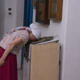 LA donna poggia la fronte sull'icona di San Nicola per qualche minuto: un modo per ringraziare di un favore ricevuto
